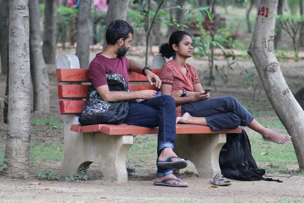 An unhappy couple on a park bench.